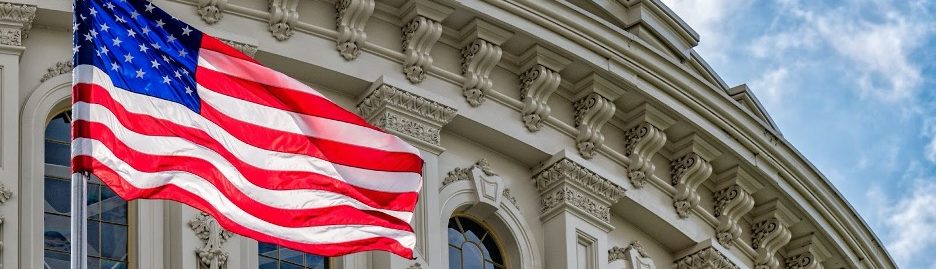 American flag waving in front of a government building