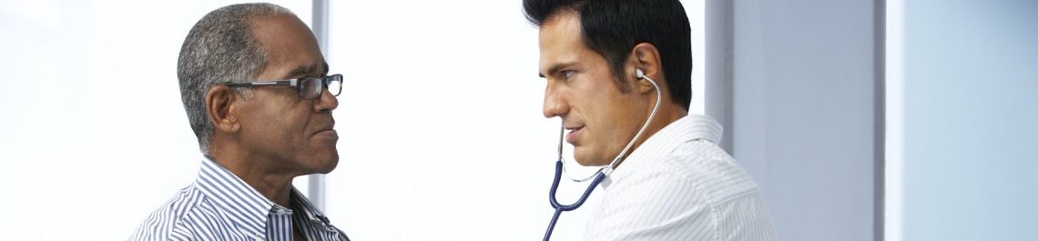 Doctor analyzing african american patient for health issues including 9/11 cancer