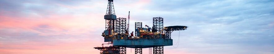 Oil rig during sunset out in the water